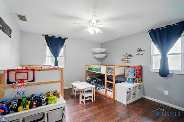 recreation room featuring visible vents, baseboards, ceiling fan, and wood finished floors