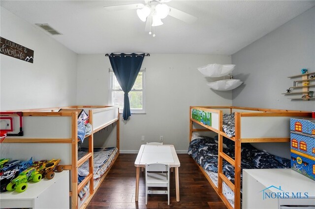 bedroom with wood-type flooring, baseboards, and visible vents