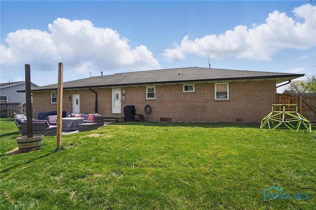 rear view of property featuring crawl space, brick siding, an outdoor hangout area, a fenced backyard, and a yard