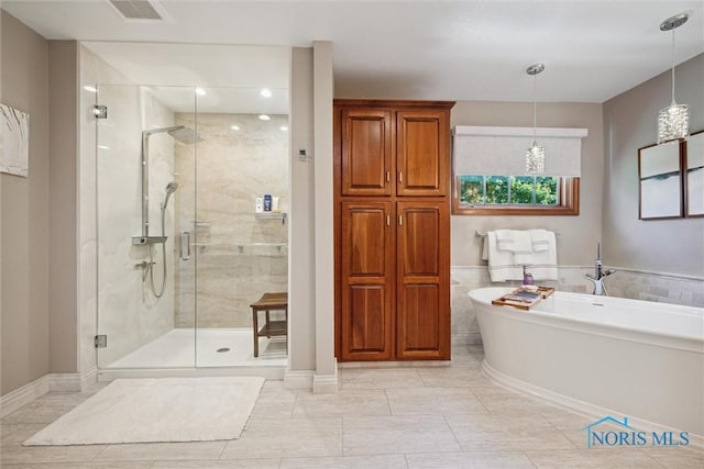 full bathroom with a freestanding bath, baseboards, visible vents, and a stall shower