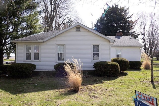 306 Lincoln St, Lyons, OH 43533 - view of home's exterior featuring a lawn, a chimney, and a shingled roof