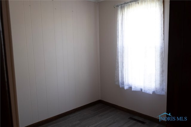 306 Lincoln St, Lyons, OH 43533 - spare room with baseboards, visible vents, and dark wood-style flooring