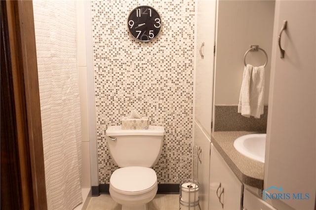 306 Lincoln St, Lyons, OH 43533 - bathroom featuring baseboards, toilet, and vanity