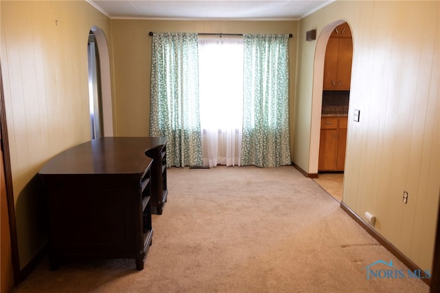 306 Lincoln St, Lyons, OH 43533 - bedroom featuring arched walkways, wood walls, light colored carpet, and ornamental molding