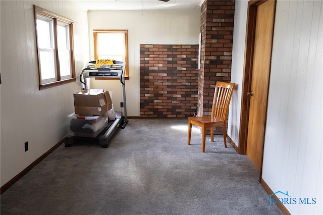 306 Lincoln St, Lyons, OH 43533 - living area featuring carpet floors, wood walls, and baseboards