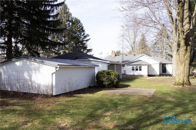 306 Lincoln St, Lyons, OH 43533 - back of house featuring a yard and metal roof