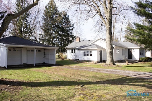306 Lincoln St, Lyons, OH 43533 - exterior space with an outbuilding and a garage