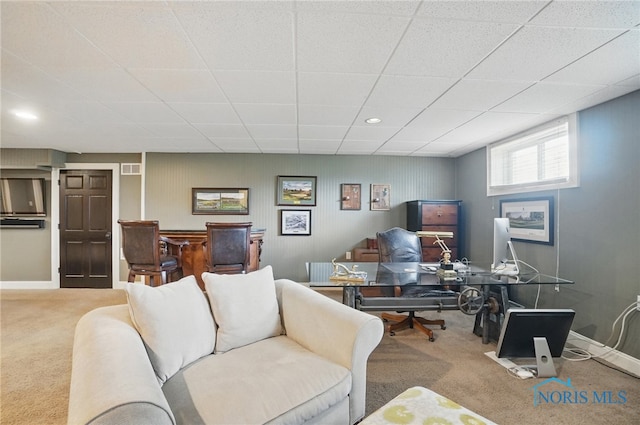 office space with radiator, carpet flooring, a drop ceiling, and baseboards