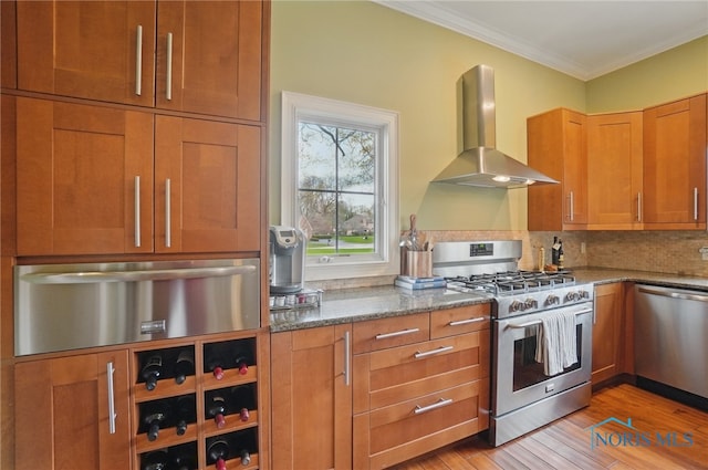 kitchen with exhaust hood, appliances with stainless steel finishes, a warming drawer, stone countertops, and crown molding