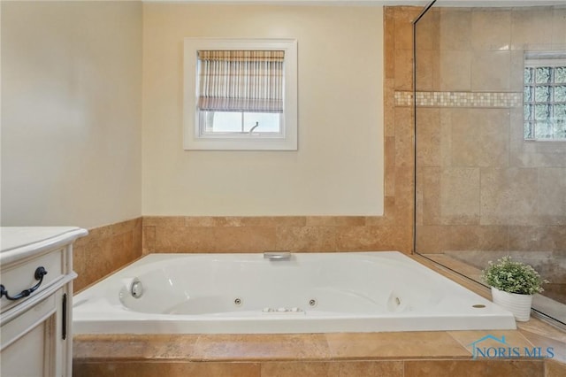 full bath featuring a tile shower, vanity, and a whirlpool tub