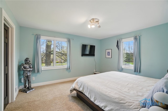 carpeted bedroom with baseboards