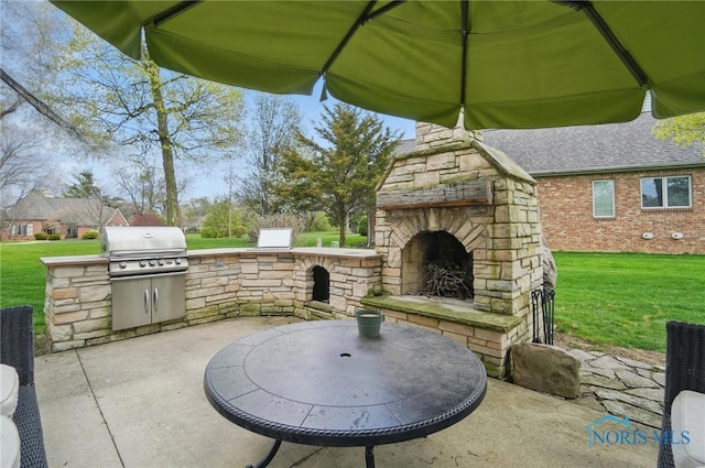 view of patio with an outdoor stone fireplace, outdoor dining space, grilling area, and area for grilling
