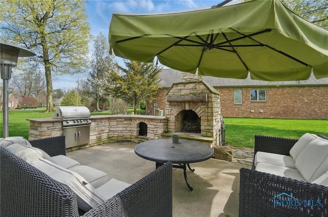 view of patio featuring an outdoor living space with a fireplace, an outdoor kitchen, and grilling area