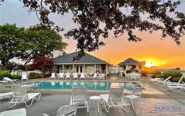 community pool with a gazebo, a patio area, french doors, and fence
