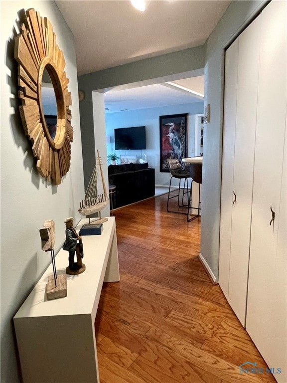 corridor featuring wood finished floors