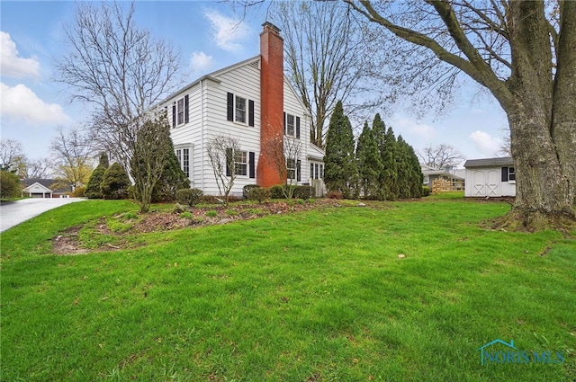 160 Winfield Dr, Bowling Green, OH 43402 - view of home's exterior with a lawn and a chimney