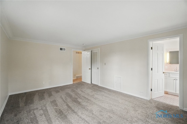 160 Winfield Dr, Bowling Green, OH 43402 - carpeted spare room with visible vents, baseboards, ornamental molding, and a sink
