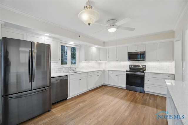 160 Winfield Dr, Bowling Green, OH 43402 - kitchen featuring light countertops, ornamental molding, a sink, appliances with stainless steel finishes, and white cabinetry