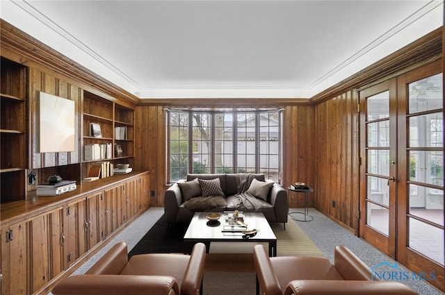 160 Winfield Dr, Bowling Green, OH 43402 - living area with wood walls, french doors, carpet flooring, and built in shelves