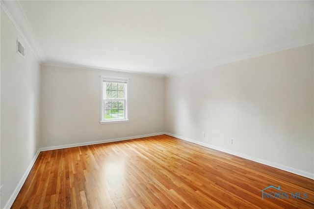 160 Winfield Dr, Bowling Green, OH 43402 - spare room featuring baseboards, visible vents, light wood-type flooring, and crown molding