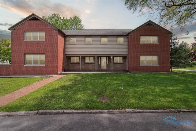 325 Park St, Bryan, OH 43506 - view of front of property with a front lawn and brick siding