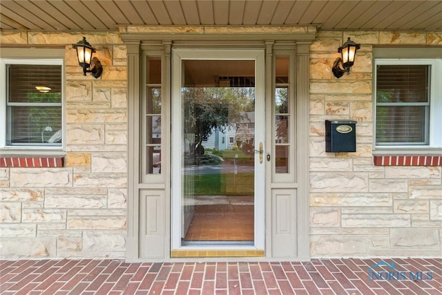 325 Park St, Bryan, OH 43506 - view of exterior entry with stone siding and covered porch