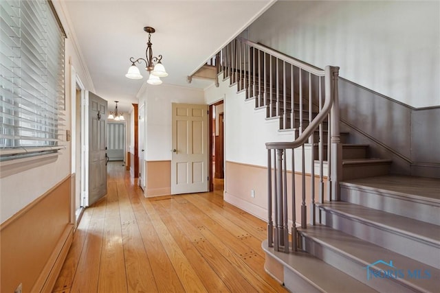 325 Park St, Bryan, OH 43506 - stairway with a chandelier, wood-type flooring, and baseboards