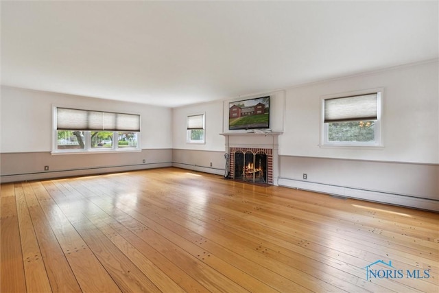 325 Park St, Bryan, OH 43506 - unfurnished living room featuring a fireplace, a baseboard heating unit, hardwood / wood-style flooring, and a baseboard radiator
