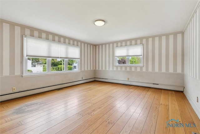 325 Park St, Bryan, OH 43506 - unfurnished room with wallpapered walls, healthy amount of natural light, and wood-type flooring