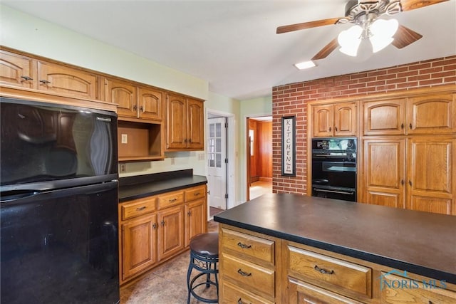 325 Park St, Bryan, OH 43506 - kitchen with black appliances, dark countertops, a ceiling fan, brown cabinetry, and brick wall