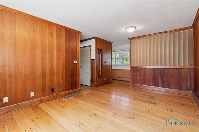 325 Park St, Bryan, OH 43506 - spare room with a baseboard radiator and wood-type flooring