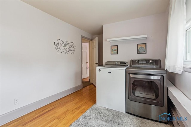 325 Park St, Bryan, OH 43506 - washroom with washing machine and clothes dryer, light wood-type flooring, and baseboards