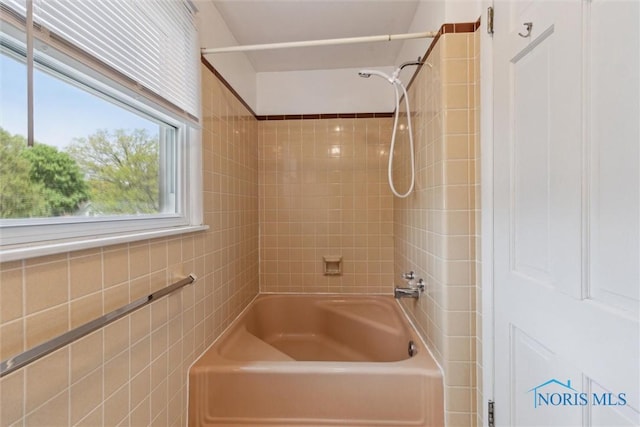 325 Park St, Bryan, OH 43506 - bathroom with tile walls and shower / tub combination