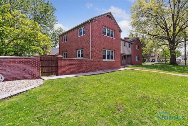 325 Park St, Bryan, OH 43506 - view of side of home featuring brick siding and a gate