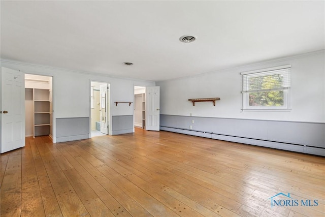 325 Park St, Bryan, OH 43506 - empty room with crown molding, light wood finished floors, and a baseboard heating unit
