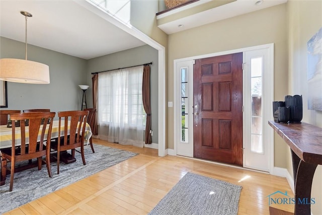 entrance foyer with baseboards and hardwood / wood-style flooring