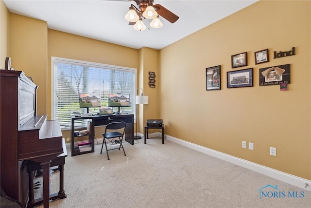 office space with carpet floors, a ceiling fan, and baseboards