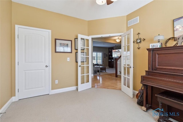 interior space featuring ceiling fan, french doors, carpet flooring, and visible vents