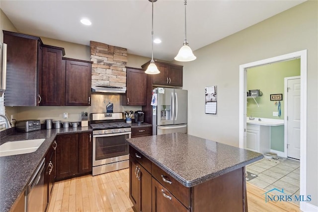 4218 Herdmans Cir, Maumee, OH 43537 - kitchen with stainless steel appliances, a sink, light wood-type flooring, hanging light fixtures, and a kitchen island