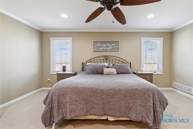 bedroom with light colored carpet, baseboards, crown molding, and visible vents