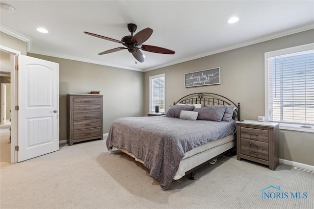 bedroom with crown molding, baseboards, multiple windows, and light colored carpet