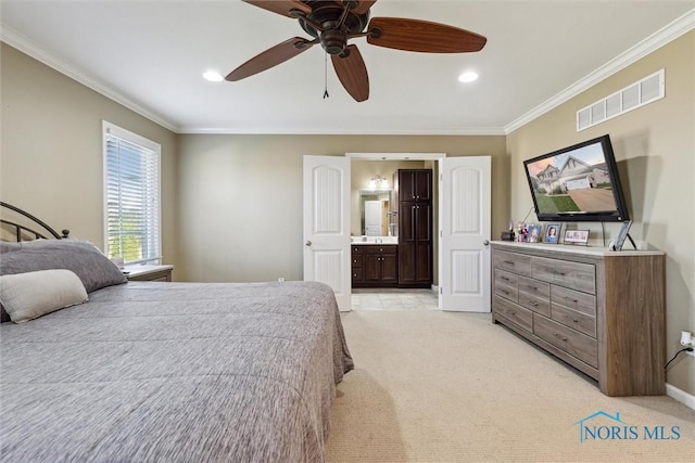 bedroom featuring ornamental molding, ensuite bathroom, light colored carpet, and visible vents