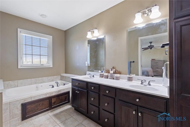 bathroom with connected bathroom, tile patterned floors, a sink, and a bath