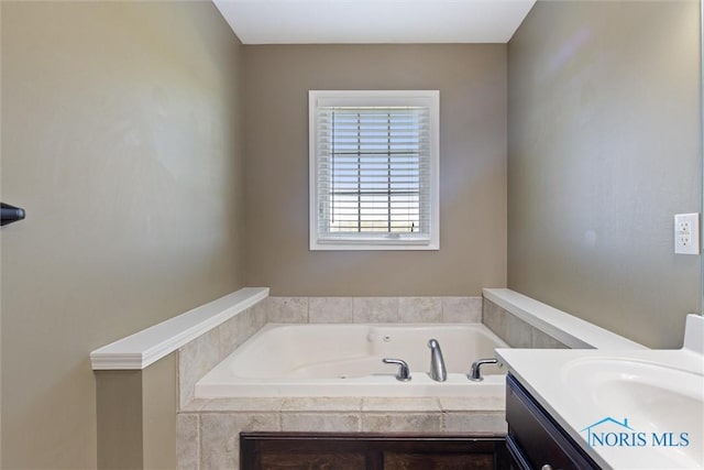 bathroom with vanity and a garden tub