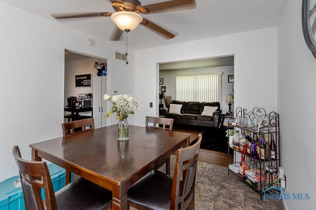 853 Circleview Dr, Toledo, OH 43615 - dining space with visible vents, a ceiling fan, and stone finish floor
