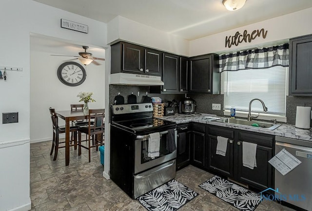 853 Circleview Dr, Toledo, OH 43615 - kitchen with a sink, stainless steel appliances, a ceiling fan, decorative backsplash, and under cabinet range hood