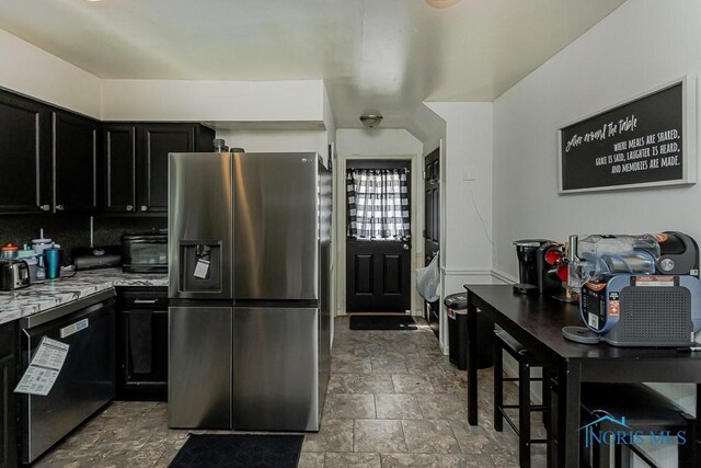 853 Circleview Dr, Toledo, OH 43615 - kitchen featuring dark cabinets, stone finish flooring, and appliances with stainless steel finishes