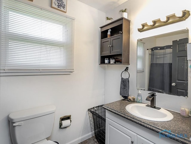 853 Circleview Dr, Toledo, OH 43615 - full bathroom featuring vanity, baseboards, walk in shower, and toilet