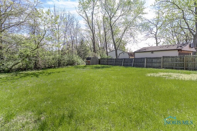 853 Circleview Dr, Toledo, OH 43615 - view of yard with a storage unit and fence
