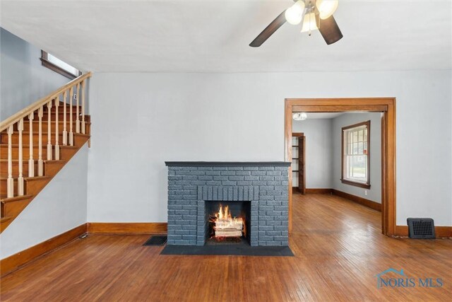2000 Oakwood Ave, Toledo, OH 43607 - unfurnished living room with stairway, wood-type flooring, baseboards, and ceiling fan